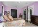 Charming bedroom with lilac walls and double doors at 1451 Lyndale Blvd, Winter Park, FL 32789