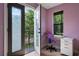 Bright bedroom with private balcony access and built-in workspace at 1451 Lyndale Blvd, Winter Park, FL 32789