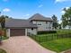 Home's side view, showcasing garage and landscaping at 1451 Lyndale Blvd, Winter Park, FL 32789