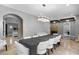 Spacious dining room with a large table, white chairs, and a modern chandelier at 1451 Lyndale Blvd, Winter Park, FL 32789
