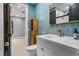 Modern bathroom with blue tile, gold fixtures, and a floating vanity at 1451 Lyndale Blvd, Winter Park, FL 32789