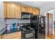 Modern kitchen with black appliances and wood cabinets at 1451 Lyndale Blvd, Winter Park, FL 32789