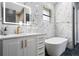 Luxurious bathroom with a freestanding tub and marble tile at 1451 Lyndale Blvd, Winter Park, FL 32789