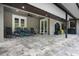 Covered patio with paver stones and outdoor seating at 1451 Lyndale Blvd, Winter Park, FL 32789