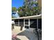 House side with screened porch and bikes at 3416 Unity Tree Dr, Edgewater, FL 32141