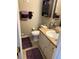 Bathroom with a vanity, toilet, and purple rugs at 3416 Unity Tree Dr, Edgewater, FL 32141