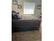 Bedroom with a wooden bed frame and carpeted floor at 3416 Unity Tree Dr, Edgewater, FL 32141