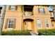 Townhouse exterior showcasing a front entrance and balcony at 2214 Calabria Ave, Davenport, FL 33897