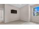 Bedroom with wood-look floors, a window, and mounted TV at 4814 Terra Sole Pl, St Cloud, FL 34771