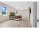 Main bedroom with light walls, wood-look flooring, and access to bathroom at 4814 Terra Sole Pl, St Cloud, FL 34771