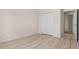 Bedroom with wood-look floors and double-door closet at 4814 Terra Sole Pl, St Cloud, FL 34771