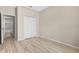 Light and bright bedroom with wood-look floors and double doors leading to the closet at 4814 Terra Sole Pl, St Cloud, FL 34771