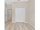 Bedroom with light walls, wood-look floors, and a double-door closet at 4814 Terra Sole Pl, St Cloud, FL 34771