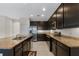 Modern kitchen features dark cabinets, granite countertops, and stainless steel appliances at 4814 Terra Sole Pl, St Cloud, FL 34771