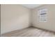 Spacious bedroom with wood-look floors and a window at 4814 Terra Sole Pl, St Cloud, FL 34771