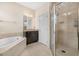 Bathroom with soaking tub, shower, and granite vanity at 4814 Terra Sole Pl, St Cloud, FL 34771