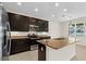 Spacious kitchen with granite countertops, dark cabinetry, and an island at 4814 Terra Sole Pl, St Cloud, FL 34771