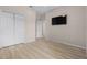 Bedroom with wood-look floors, a window, and mounted TV at 4814 Terra Sole Pl, St Cloud, FL 34771