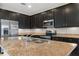 Kitchen with dark cabinets, granite countertops and stainless steel appliances at 4814 Terra Sole Pl, St Cloud, FL 34771