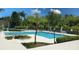 Community pool with lounge chairs and lush landscaping at 625 Dory Ln # 201, Altamonte Springs, FL 32714