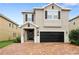 Two-story home with a two-car garage and attractive brick driveway at 7513 Marker Ave, Kissimmee, FL 34747