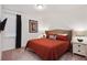 Spacious bedroom with a king-size bed and mounted TV at 7513 Marker Ave, Kissimmee, FL 34747