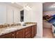 Double-sink bathroom with granite countertop and large mirror at 7513 Marker Ave, Kissimmee, FL 34747