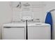 Laundry room with washer, dryer, and shelving at 7513 Marker Ave, Kissimmee, FL 34747
