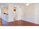 Living room with hardwood floors and kitchen access at 6624 Time Square Ave # 104, Orlando, FL 32835