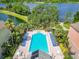 Community pool with plenty of lounge chairs and a hot tub at 6624 Time Square Ave # 104, Orlando, FL 32835