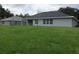 Spacious backyard with large grassy area, providing ample space for outdoor activities at 541 Rhodes Dr, Deland, FL 32720