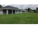 Expansive backyard with grassy area and view of neighboring houses at 541 Rhodes Dr, Deland, FL 32720