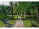 Brick pathway leads to footbridge over a serene pond at 201 Weeping Elm Ln, Longwood, FL 32779