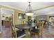 Bright dining room with a dark wood table and chandelier at 201 Weeping Elm Ln, Longwood, FL 32779