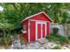 Bright red storage shed with white trim at 331 Douglas Dr, Eustis, FL 32726