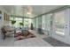 Relaxing sunroom with tiled floor, seating, and ceiling fan at 331 Douglas Dr, Eustis, FL 32726