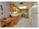 Bright kitchen features wood cabinets, tile floor, and stainless steel appliances at 331 Douglas Dr, Eustis, FL 32726