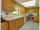 View of kitchen with wood cabinets, tile floor, and stainless steel appliances at 331 Douglas Dr, Eustis, FL 32726