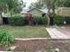 Landscaped backyard with a spacious grassy area and brick patio at 331 Douglas Dr, Eustis, FL 32726