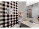 Modern bathroom with black and white checkered wallpaper at 3136 Porta Romano Way, Lake Mary, FL 32746