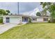 House exterior with solar panels and a spacious yard at 1522 Gainesville Dr, Deltona, FL 32725