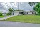 House exterior showcasing a well-maintained lawn and solar panels at 1522 Gainesville Dr, Deltona, FL 32725