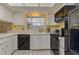 Galley kitchen with black appliances and ample counter space at 1522 Gainesville Dr, Deltona, FL 32725