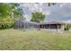 Large backyard with a screened-in pool and lush landscaping at 1522 Gainesville Dr, Deltona, FL 32725