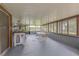 Bright and airy screened porch with ample seating at 1522 Gainesville Dr, Deltona, FL 32725