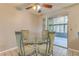 Bright dining area with glass table and four chairs, leading to a screened porch at 1522 Gainesville Dr, Deltona, FL 32725