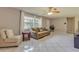 Living room with tiled floors, couch, and side chair near windows at 1522 Gainesville Dr, Deltona, FL 32725
