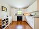 Modern white kitchen with wood floors and ample counter space at 509 South St, Fern Park, FL 32730