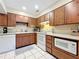 Kitchen features wood cabinets, white appliances, and tile floors at 509 South St, Fern Park, FL 32730