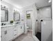 Modern bathroom with double vanity, frameless shower, and gray tile at 30931 Sunset Dr, Tavares, FL 32778